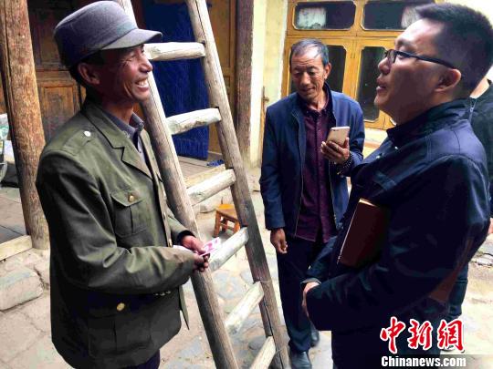 图为“第一书记”杨同业慰问贫困户。 李隽 摄