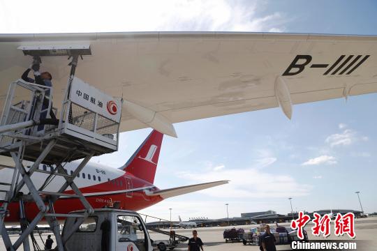 地面工作人员正在为飞机加油。 殷立勤 摄