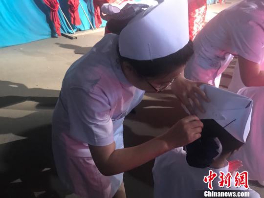 山西省级医院的护理前辈为即将奔赴护理岗位的护生戴上燕尾帽,点燃红烛。 杨静 摄